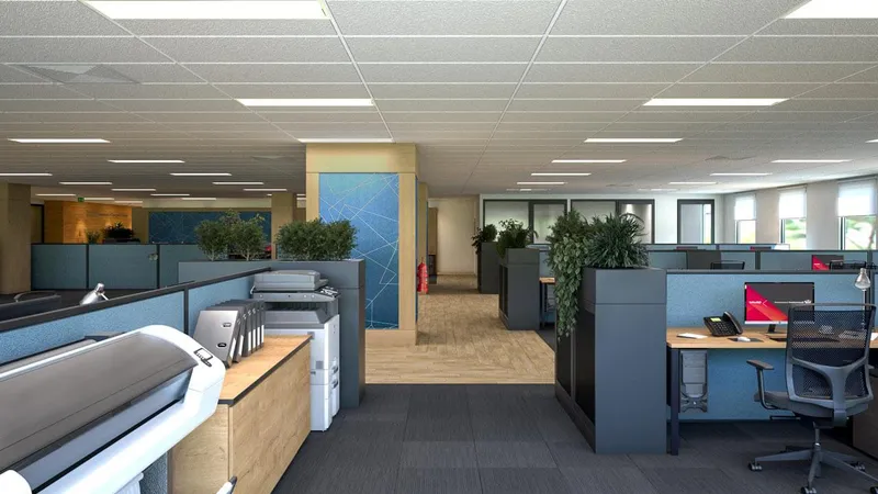 Print and workstation zone with open desks, acoustic panels, and indoor planting at QBuild's South Coast Offices.