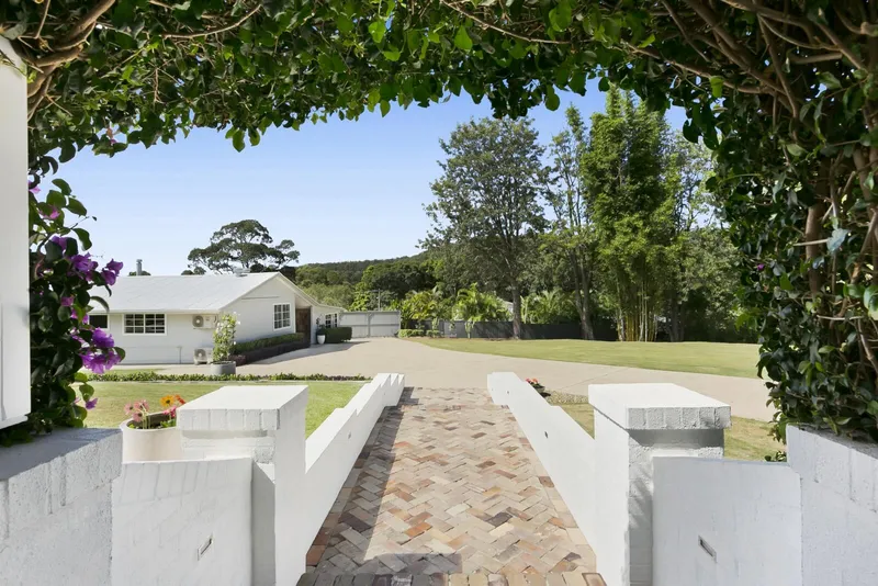 Tallebudgera Homestead - Heritage homestead exterior showing preserved traditional architecture and vine-covered portico entrance