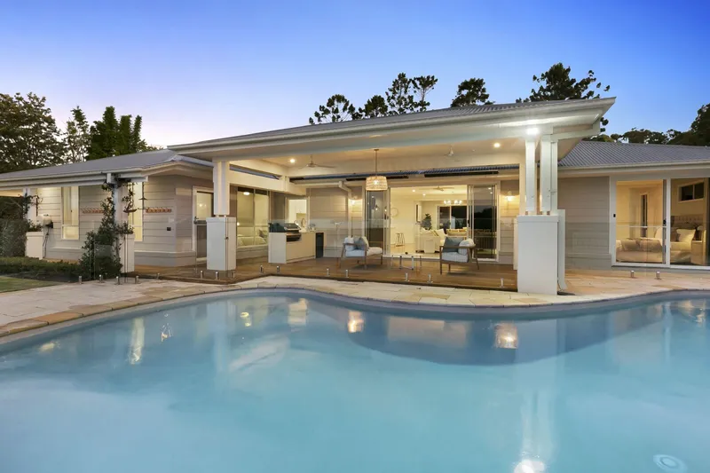 Tallebudgera Homestead - Sandstone paving and pool area creating distinct lounging and recreation zones